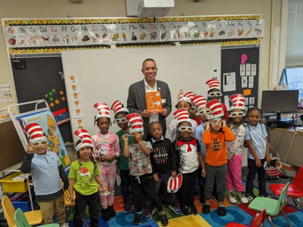 A group of children in front of dr. Seuss characters