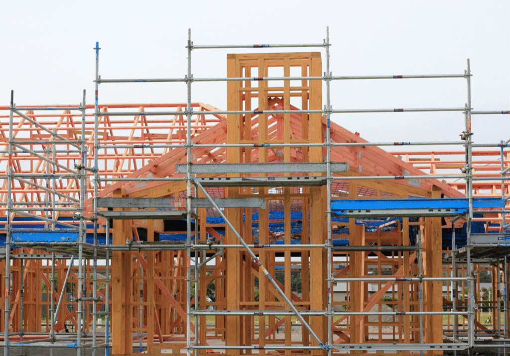 Untitled design (3) A building under construction with scaffolding around it.